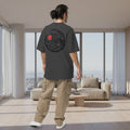 Person wearing a dark gray t-shirt with a graphic on the back, standing against a white background